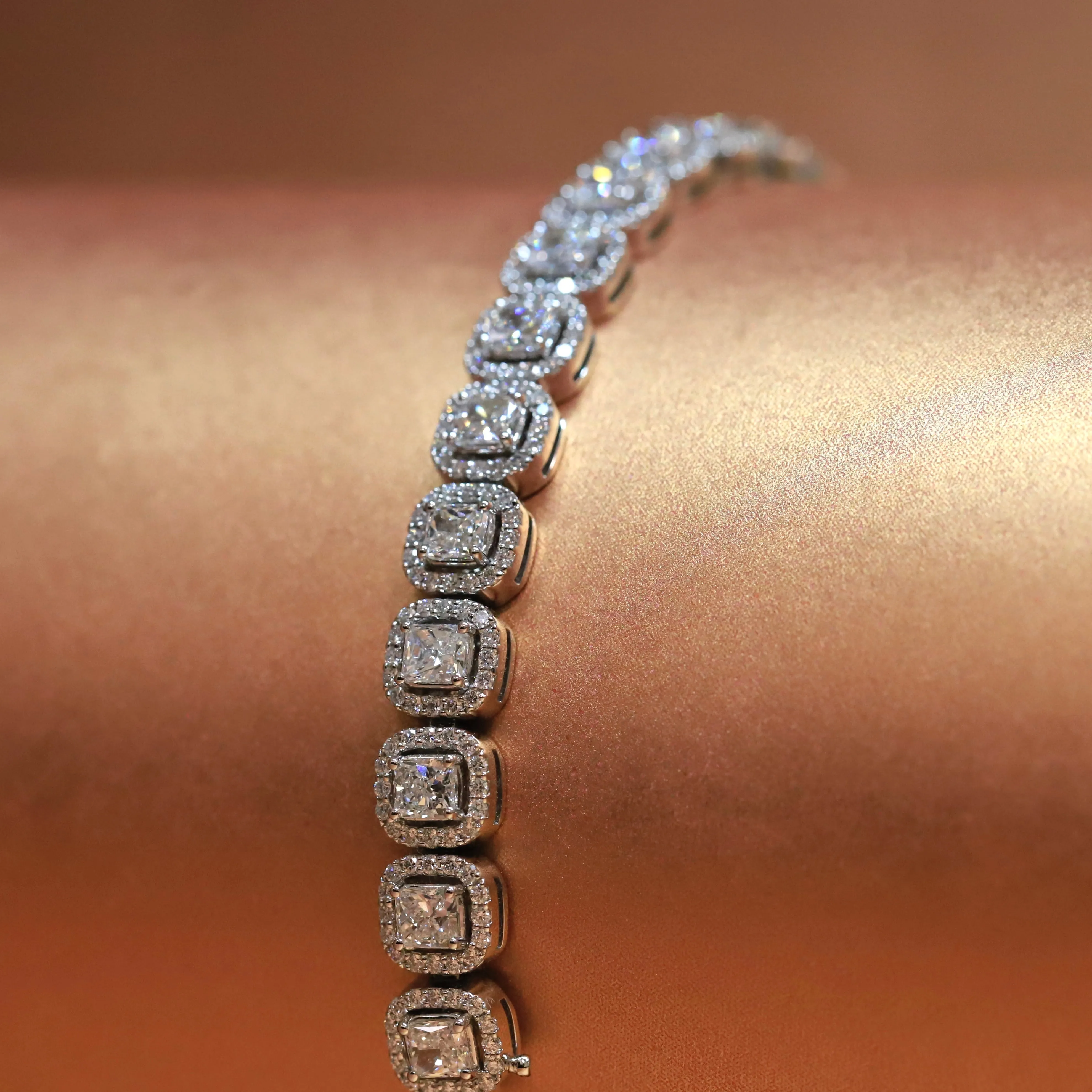 18ct White Gold Diamond Bracelet with Radiant Cut Diamonds and Round Brilliant Halo setting